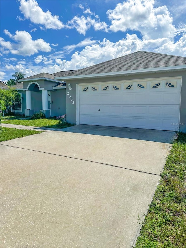 2333 Ainsworth Ave, Deltona, FL 32738 - ranch-style home featuring concrete driveway, stucco siding, and a garage