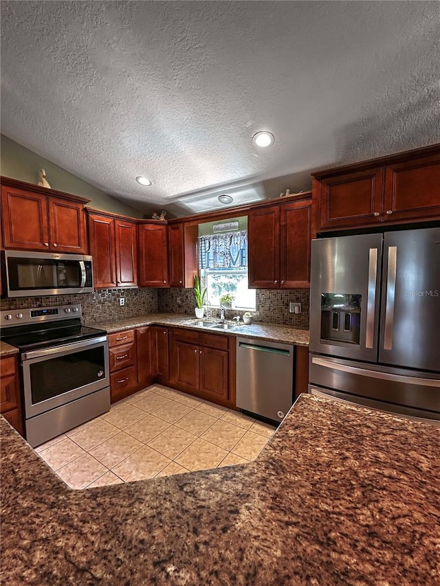 2333 Ainsworth Ave, Deltona, FL 32738 - kitchen with stainless steel appliances, decorative backsplash, light tile patterned floors, a textured ceiling, and recessed lighting
