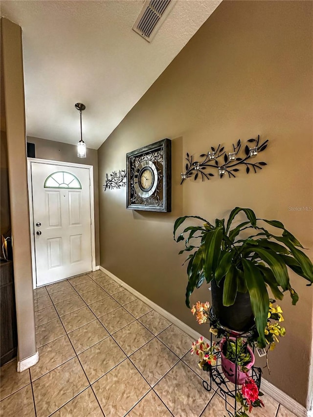 2333 Ainsworth Ave, Deltona, FL 32738 - tiled entrance foyer with lofted ceiling and baseboards
