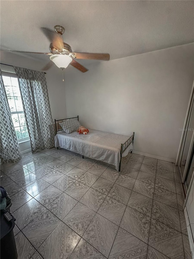 2333 Ainsworth Ave, Deltona, FL 32738 - tiled bedroom featuring ceiling fan and baseboards
