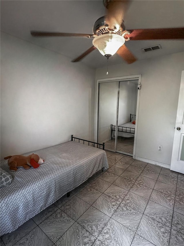 2333 Ainsworth Ave, Deltona, FL 32738 - tiled bedroom featuring a closet and ceiling fan