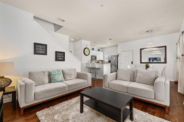 5372 Diplomat Ct Unit 108, Kissimmee, FL 34746 - living room featuring stairway, dark wood finished floors, a chandelier, and recessed lighting