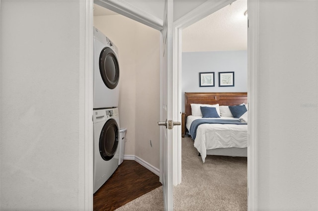 5372 Diplomat Ct Unit 108, Kissimmee, FL 34746 - laundry area featuring stacked washer / dryer and dark colored carpet