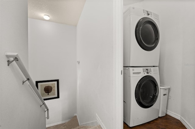 5372 Diplomat Ct Unit 108, Kissimmee, FL 34746 - laundry area with stacked washer and clothes dryer and baseboards