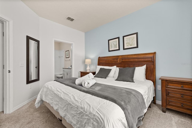 5372 Diplomat Ct Unit 108, Kissimmee, FL 34746 - carpeted bedroom featuring baseboards and ensuite bathroom