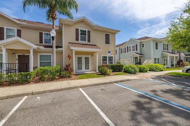 5372 Diplomat Ct Unit 108, Kissimmee, FL 34746 - view of front of property featuring french doors, uncovered parking, and a residential view