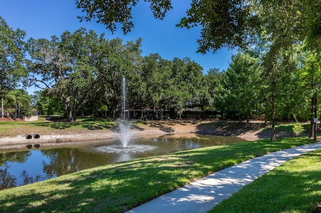 5372 Diplomat Ct Unit 108, Kissimmee, FL 34746 - view of property's community featuring a water view, a lawn, and view of wooded area