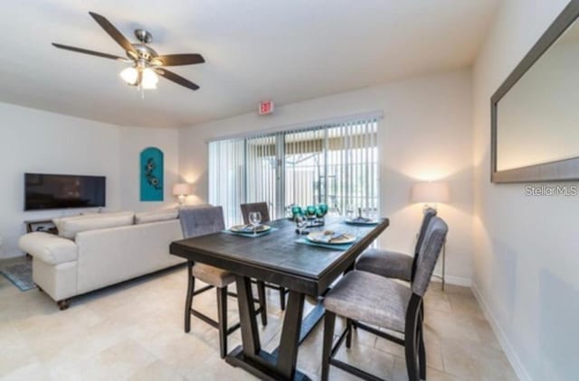 4710 Terrasonesta Dr, Davenport, FL 33837 - dining room featuring a ceiling fan and baseboards