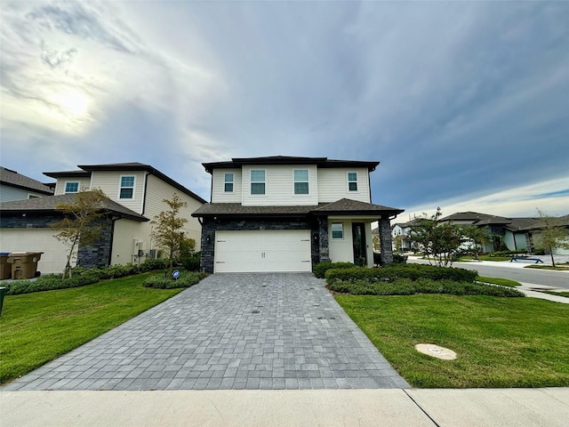 1399 Greenfield Loop, Kissimmee, FL 34747 - view of front of home featuring decorative driveway, an attached garage, a front lawn, and stone siding