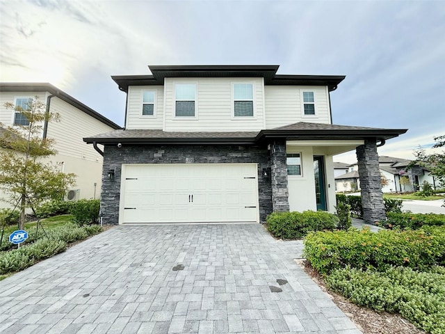 1399 Greenfield Loop, Kissimmee, FL 34747 - view of front of property featuring decorative driveway, an attached garage, and stone siding