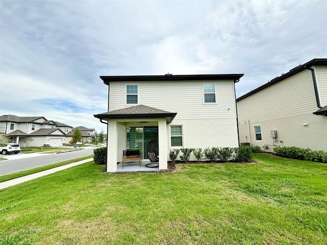 1399 Greenfield Loop, Kissimmee, FL 34747 - rear view of property with a ceiling fan, a lawn, and a patio area