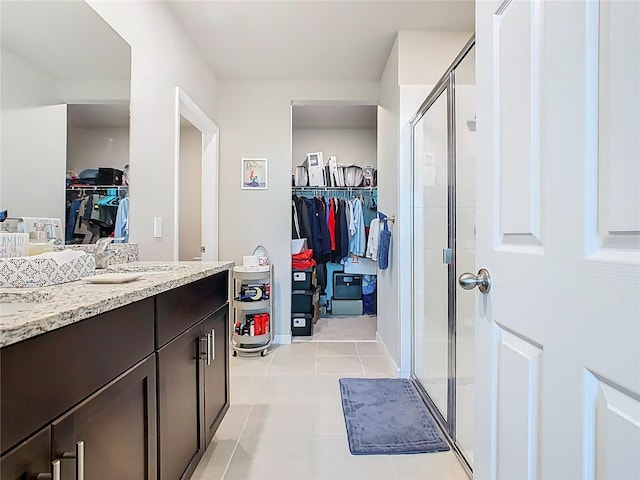 509 Mckenna Dr, Winter Haven, FL 33881 - full bathroom featuring a spacious closet, vanity, a shower stall, and tile patterned floors