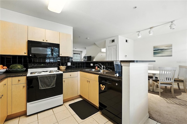 742 Centervale Dr Unit 742, Celebration, FL 34747 - kitchen with black appliances, a peninsula, decorative backsplash, and dark countertops