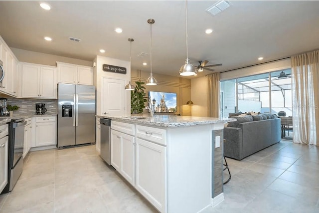 4254 Lana Ave, Davenport, FL 33897 - kitchen featuring stainless steel appliances, a ceiling fan, tasteful backsplash, white cabinets, and recessed lighting