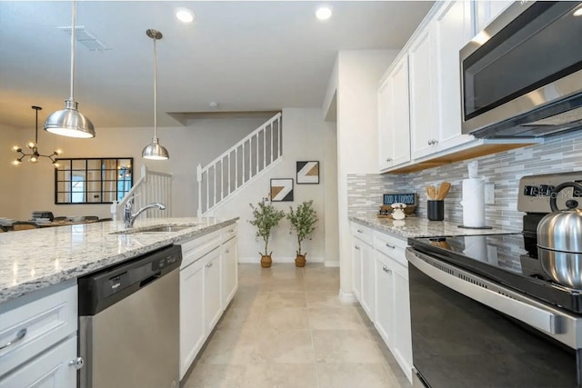 4254 Lana Ave, Davenport, FL 33897 - kitchen featuring appliances with stainless steel finishes, backsplash, light tile patterned floors, white cabinetry, and recessed lighting