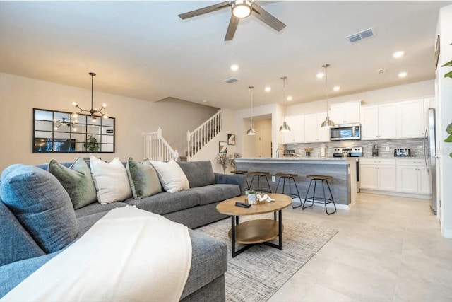 4254 Lana Ave, Davenport, FL 33897 - living area featuring ceiling fan, recessed lighting, a chandelier, and stairs