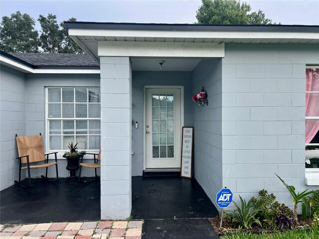 712 Cockatoo Ct, Kissimmee, FL 34759 - property entrance with concrete block siding and roof with shingles