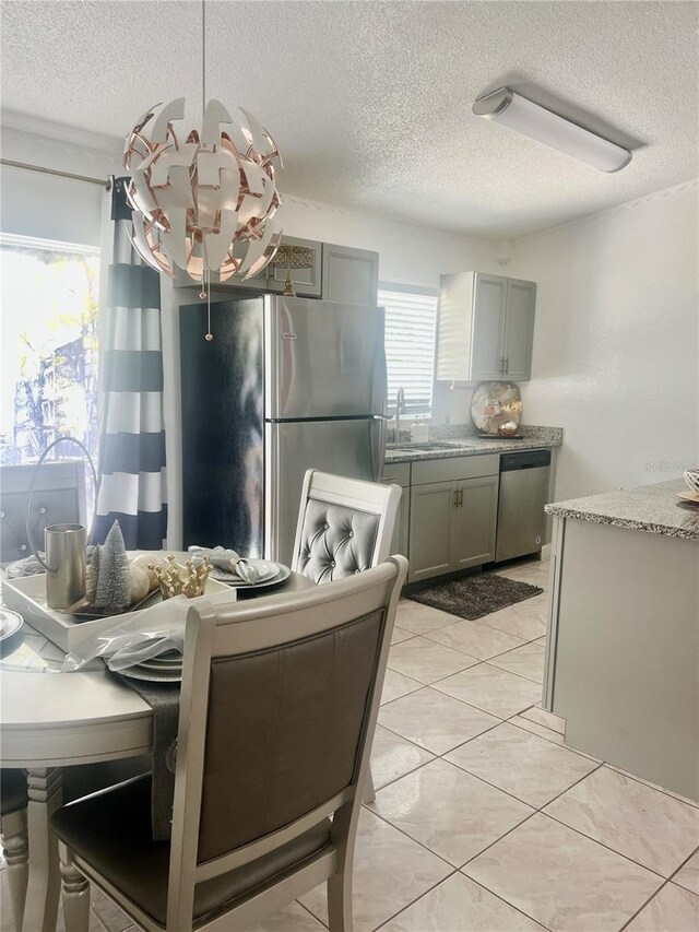 712 Cockatoo Ct, Kissimmee, FL 34759 - dining area with a textured ceiling and light tile patterned floors