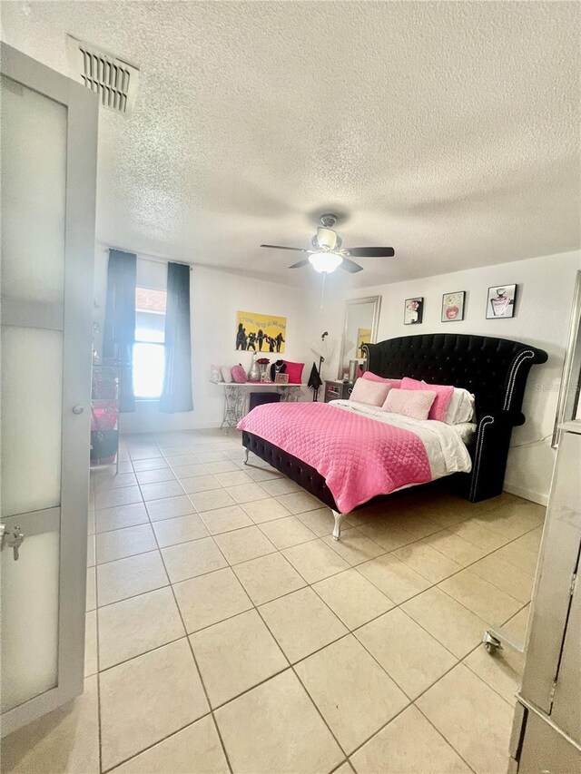 712 Cockatoo Ct, Kissimmee, FL 34759 - bedroom with light tile patterned floors, a textured ceiling, and a ceiling fan