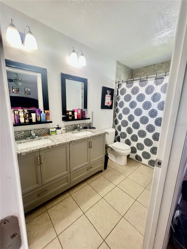 712 Cockatoo Ct, Kissimmee, FL 34759 - bathroom with a textured ceiling, double vanity, tile patterned floors, and a shower with shower curtain