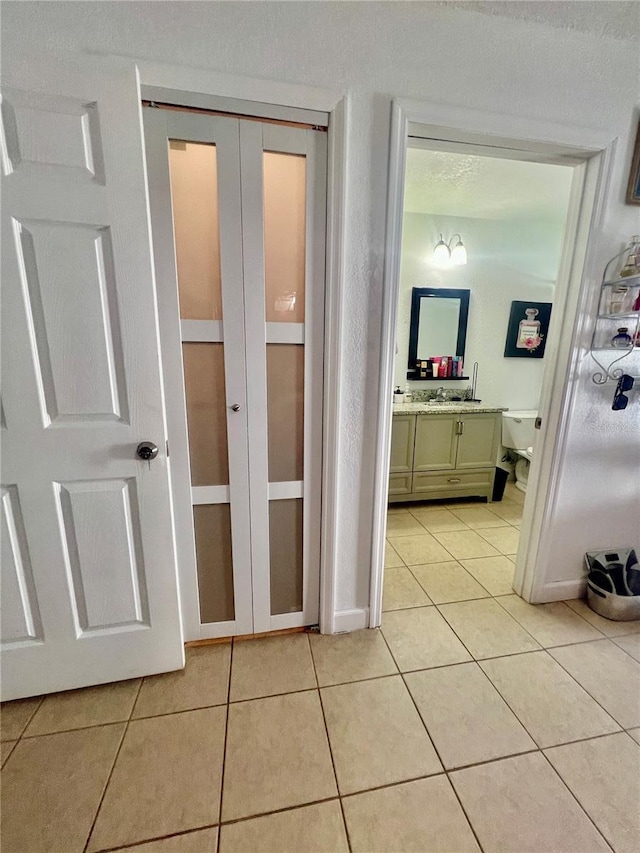 712 Cockatoo Ct, Kissimmee, FL 34759 - hallway with light tile patterned floors and baseboards