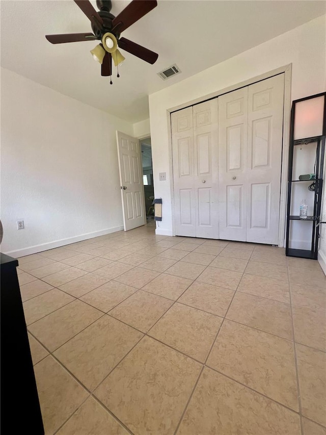 712 Cockatoo Ct, Kissimmee, FL 34759 - unfurnished bedroom with light tile patterned flooring, a ceiling fan, and a closet