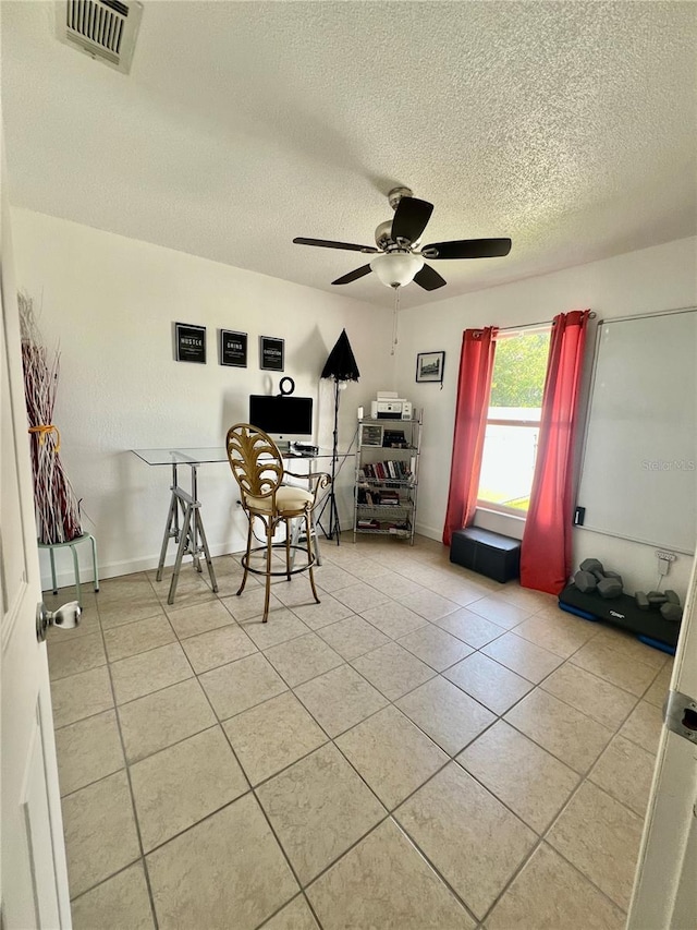 712 Cockatoo Ct, Kissimmee, FL 34759 - home office featuring light tile patterned flooring, ceiling fan, and a textured ceiling