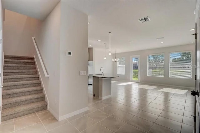 1851 Terrapin Rd, Ocoee, FL 34761 - stairway featuring tile patterned floors, recessed lighting, and a chandelier