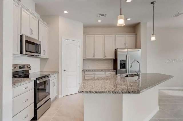 1851 Terrapin Rd, Ocoee, FL 34761 - kitchen with appliances with stainless steel finishes, light tile patterned flooring, light stone countertops, decorative backsplash, and pendant lighting