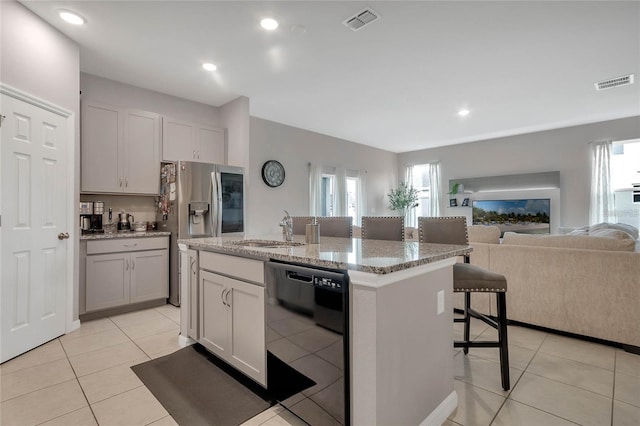 2661 Grasmere View Pkwy, Kissimmee, FL 34746 - kitchen featuring black dishwasher, open floor plan, plenty of natural light, a kitchen breakfast bar, and recessed lighting