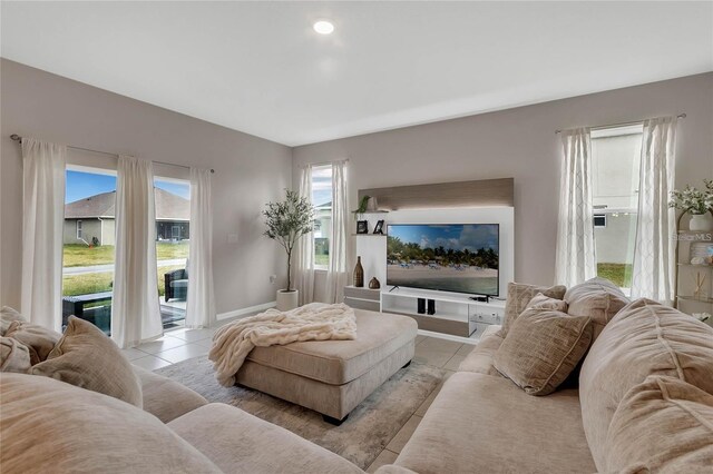 2661 Grasmere View Pkwy, Kissimmee, FL 34746 - living room featuring light tile patterned flooring and baseboards