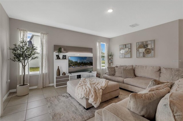 2661 Grasmere View Pkwy, Kissimmee, FL 34746 - living room with light tile patterned floors and baseboards