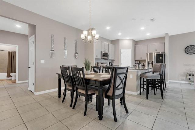 2661 Grasmere View Pkwy, Kissimmee, FL 34746 - dining area featuring light tile patterned floors, a chandelier, and recessed lighting