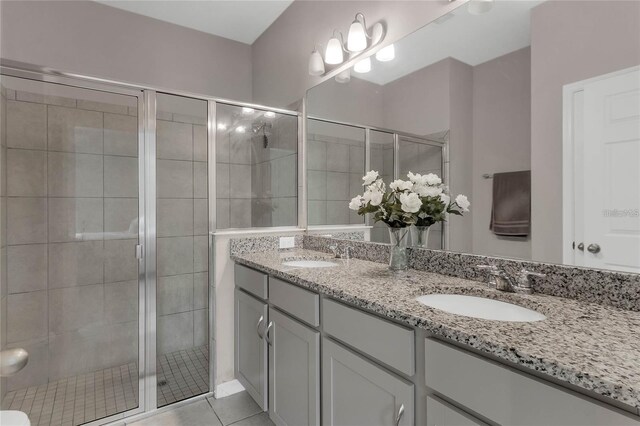 2661 Grasmere View Pkwy, Kissimmee, FL 34746 - full bath with double vanity, a shower stall, and tile patterned floors