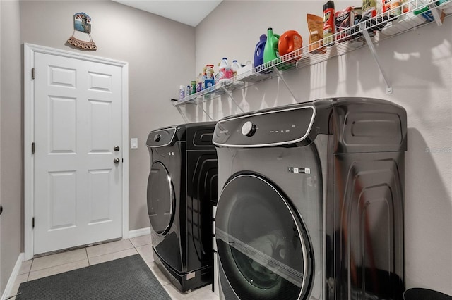 2661 Grasmere View Pkwy, Kissimmee, FL 34746 - laundry room featuring washing machine and dryer and light tile patterned flooring