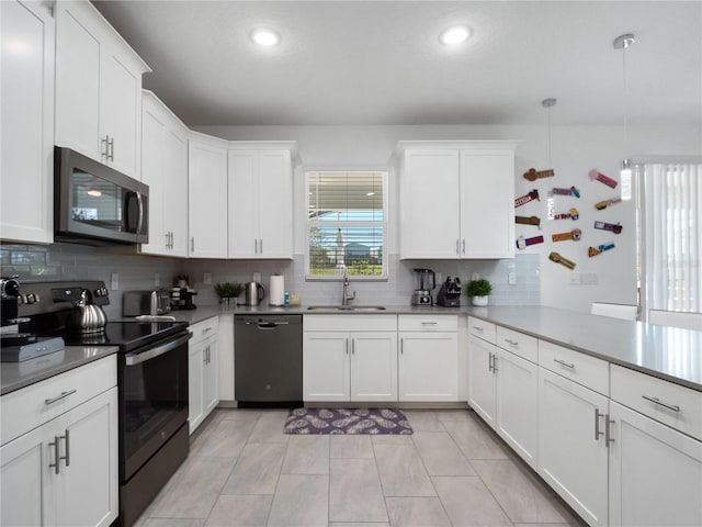 681 Pebble Beach Dr, Davenport, FL 33896 - kitchen featuring electric range oven, dishwasher, stainless steel microwave, backsplash, and recessed lighting