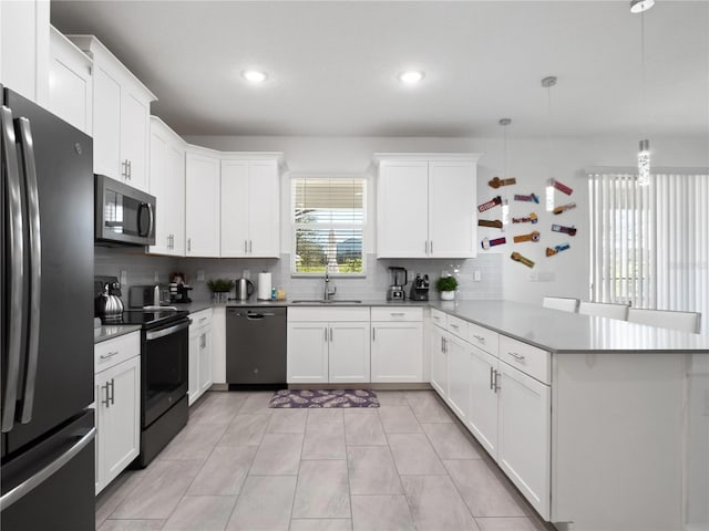 681 Pebble Beach Dr, Davenport, FL 33896 - kitchen featuring dishwashing machine, freestanding refrigerator, stainless steel microwave, range with electric cooktop, and a peninsula