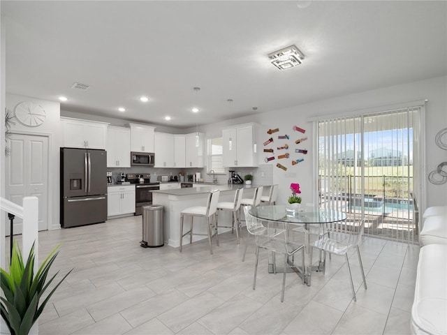 681 Pebble Beach Dr, Davenport, FL 33896 - dining area with recessed lighting and light tile patterned flooring