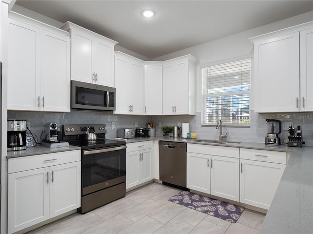 681 Pebble Beach Dr, Davenport, FL 33896 - kitchen with appliances with stainless steel finishes, decorative backsplash, white cabinets, recessed lighting, and light countertops