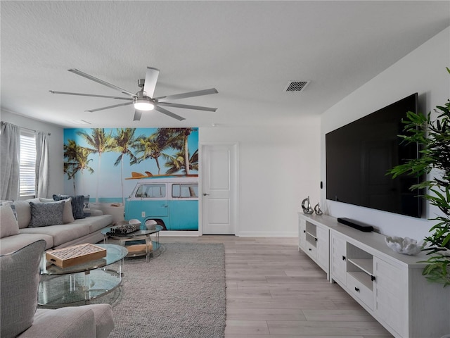 681 Pebble Beach Dr, Davenport, FL 33896 - living area featuring a ceiling fan and light wood finished floors