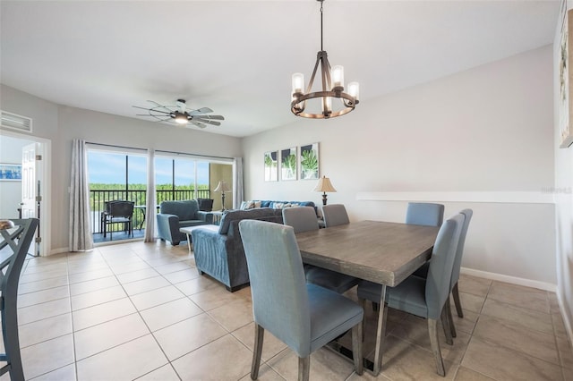 8774 Worldquest Blvd Unit 7404, Orlando, FL 32821 - dining room with light tile patterned floors, a chandelier, and a ceiling fan