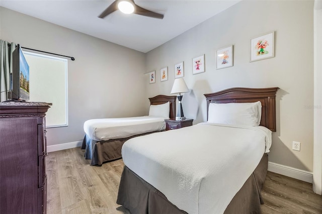 8774 Worldquest Blvd Unit 7404, Orlando, FL 32821 - bedroom featuring light wood finished floors and a ceiling fan