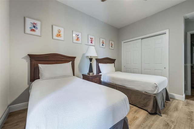 8774 Worldquest Blvd Unit 7404, Orlando, FL 32821 - bedroom featuring light wood finished floors and a closet