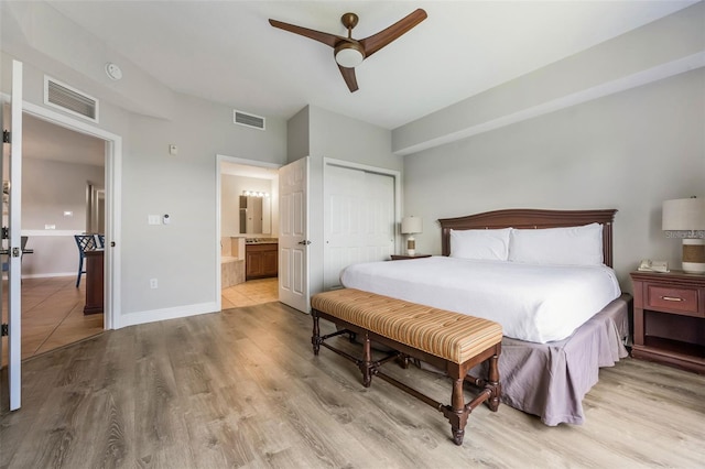 8774 Worldquest Blvd Unit 7404, Orlando, FL 32821 - bedroom featuring wood finished floors, a closet, ensuite bath, and a ceiling fan