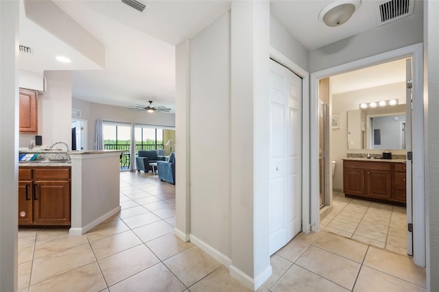 8774 Worldquest Blvd Unit 7404, Orlando, FL 32821 - hallway with light tile patterned flooring and a sink