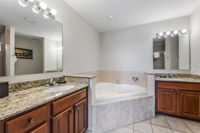 8774 Worldquest Blvd Unit 7404, Orlando, FL 32821 - full bath featuring two vanities, a shower stall, tile patterned flooring, and a bath