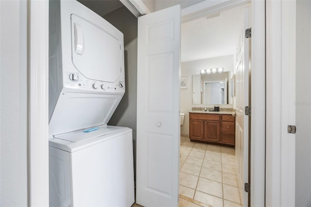 8774 Worldquest Blvd Unit 7404, Orlando, FL 32821 - laundry room with estacked washer and dryer and light tile patterned flooring
