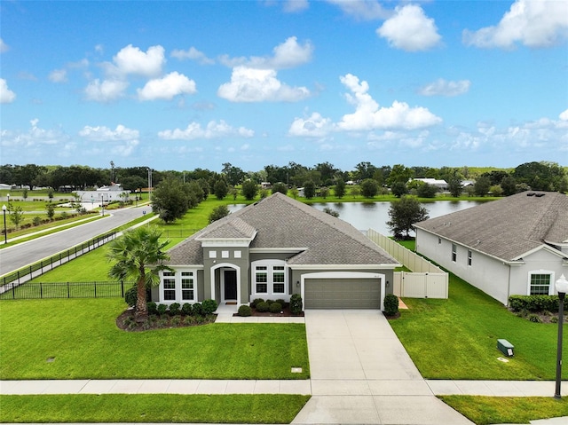 1817 Westerham Ave, Saint Cloud, FL 34771 - view of front of property featuring an attached garage, stucco siding, concrete driveway, a shingled roof, and a water view
