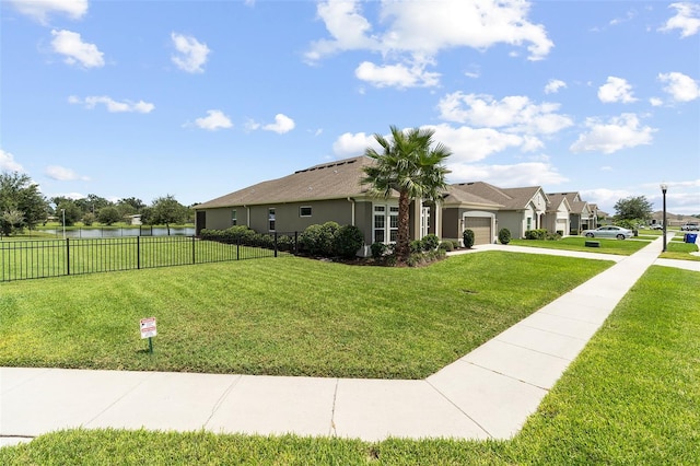 1817 Westerham Ave, Saint Cloud, FL 34771 - view of front facade featuring an attached garage, driveway, a water view, and stucco siding