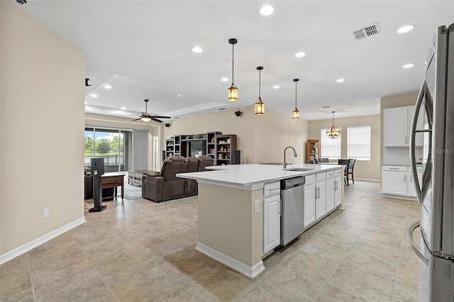 1817 Westerham Ave, Saint Cloud, FL 34771 - kitchen with appliances with stainless steel finishes, recessed lighting, white cabinetry, ceiling fan, and a center island with sink